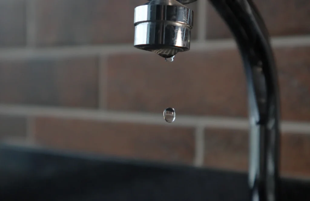 Faucet with a water drop hanging from it